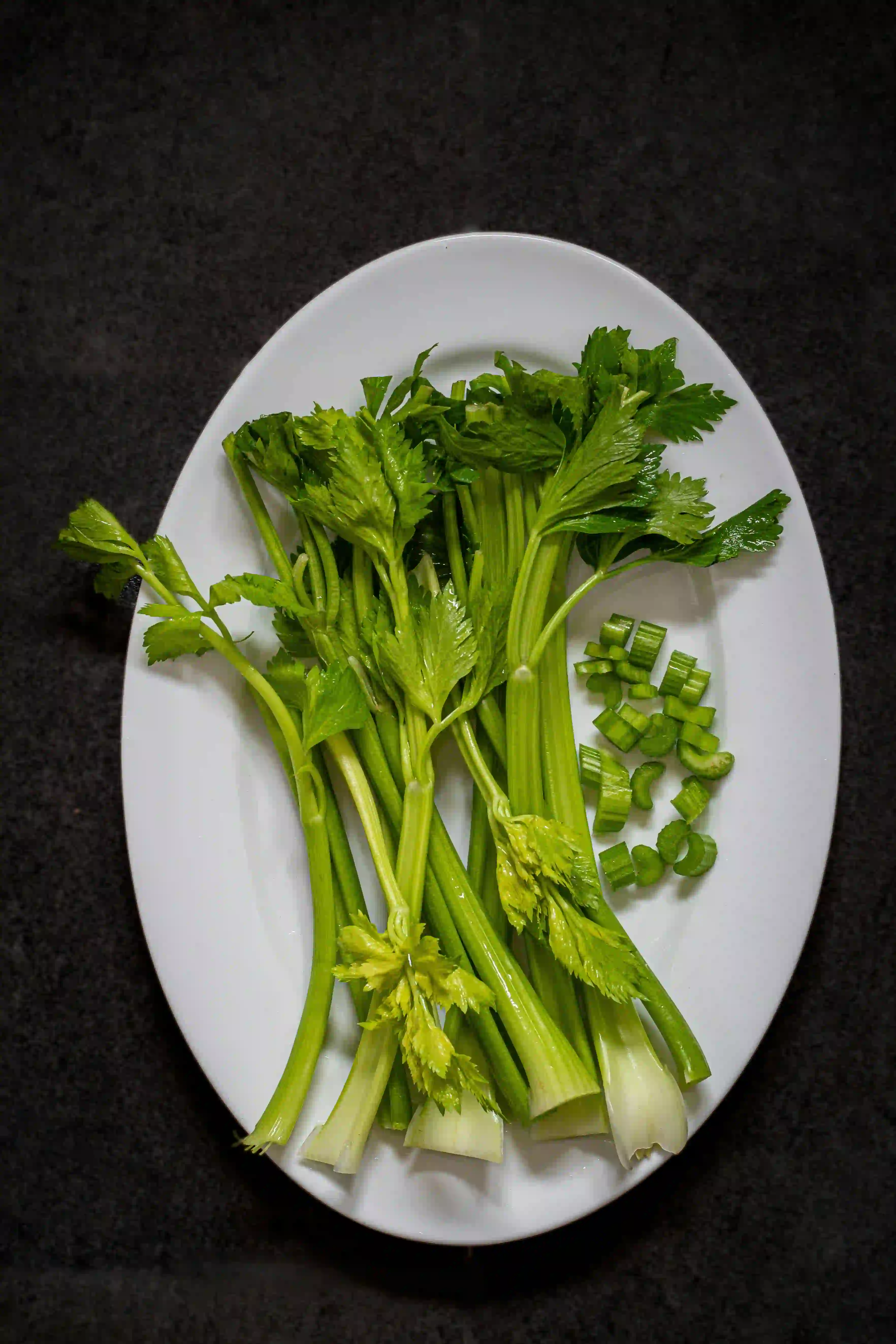 celery on white plate with black background on celery nutrition