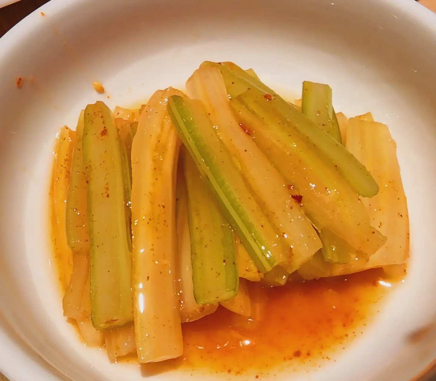 A plate of crunchy normal Celery Kimchi on a white table